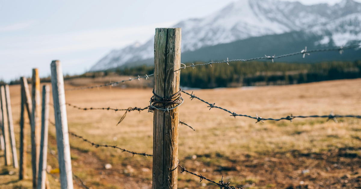 how to run barbed wire fence